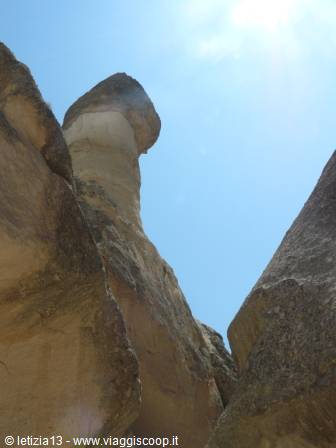 Fairy chimney rock formation in Cappadocia, blue sky and sunlight