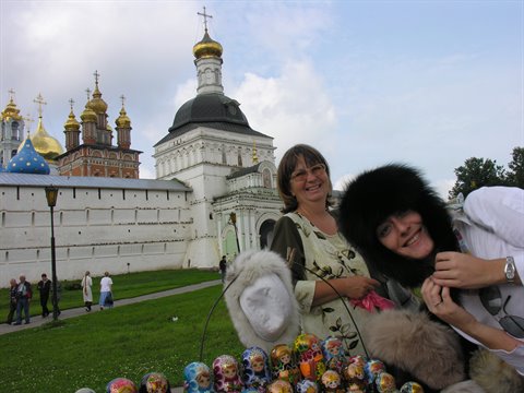 Women trying fur hats near matryoshka stalls at the Trinity Lavra, Sergiev Posad