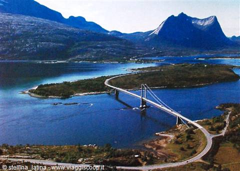Suspension bridge crossing a fjord among green islands and rocky mountains