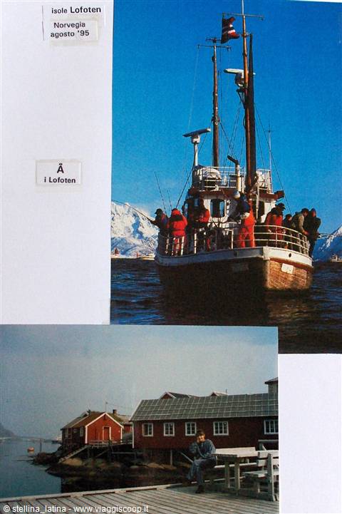 Tourists in orange suits on a fishing boat at Å, Lofoten, red cabins on the dock