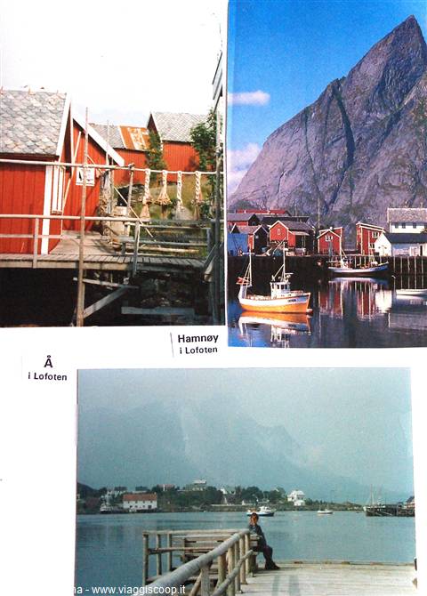 Hamnøy, Lofoten: red rorbu huts on stilts, yellow fishing boat in harbor beneath mountain