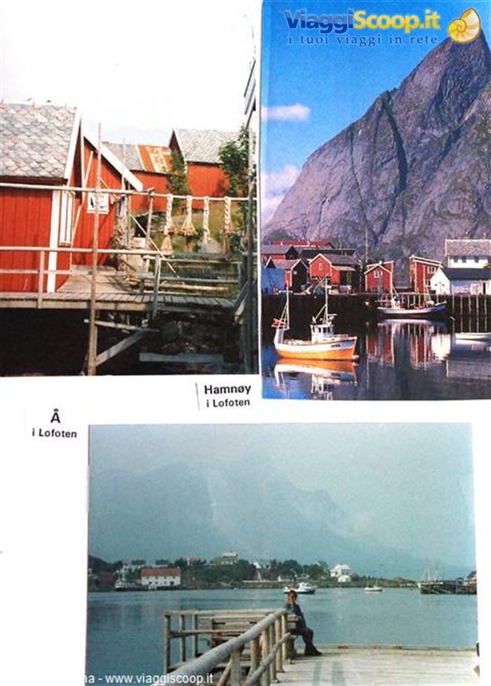Hamnøy, Lofoten: red rorbu huts on stilts, yellow fishing boat in harbor beneath mountain