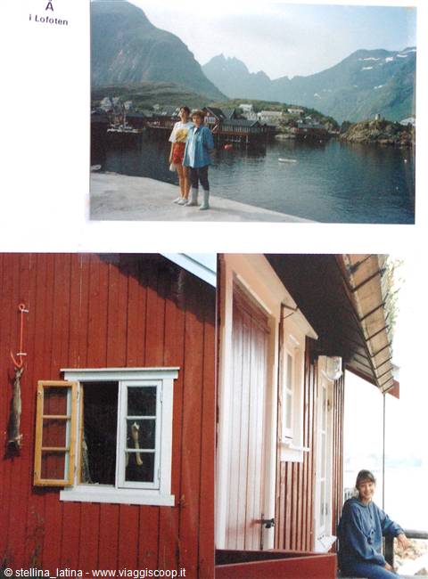 Two girls on Lofoten pier, red wooden rorbu cabins and mountains over the fjord