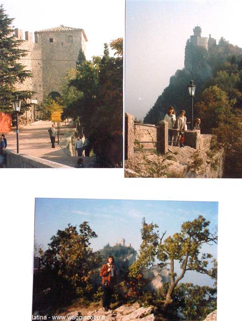 Tourists near Guaita tower in San Marino, stone walls and rocky cliff