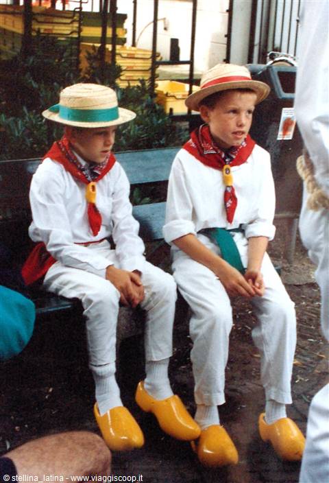 Boys in traditional Dutch costume with straw hats and yellow wooden clogs