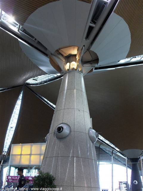 Granite column with mushroom-shaped roof canopy inside Kuala Lumpur's KLIA terminal