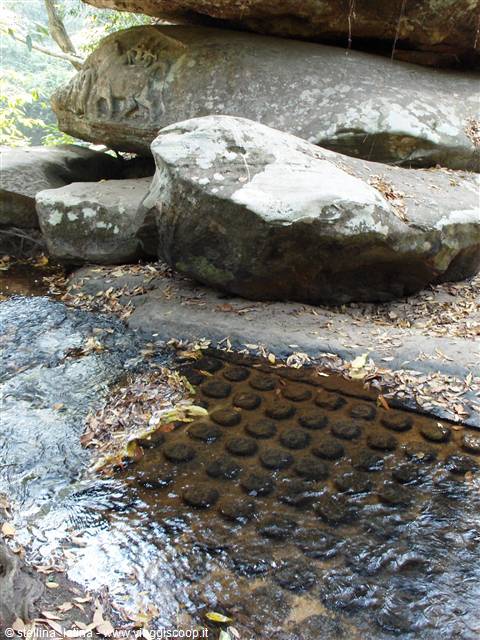 Carved lingas in the riverbed among mossy boulders, Kbal Spean
