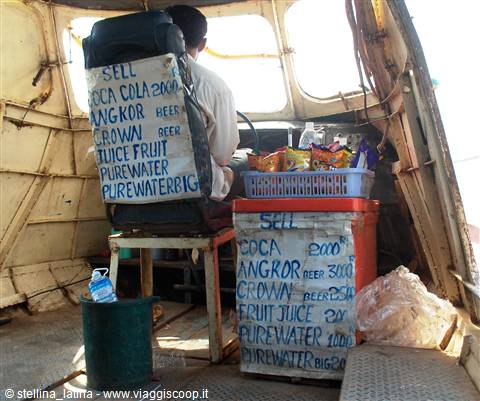 Boat interior with handwritten drink price list, snack baskets and vendor