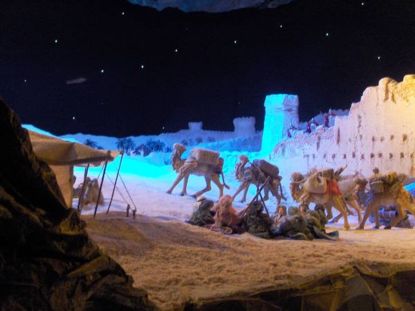 Mechanical nativity scene with camels and figures under starry lights