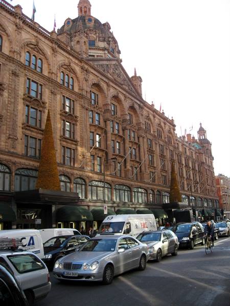 Harrods' Victorian terracotta facade in London, Christmas decorations, traffic below