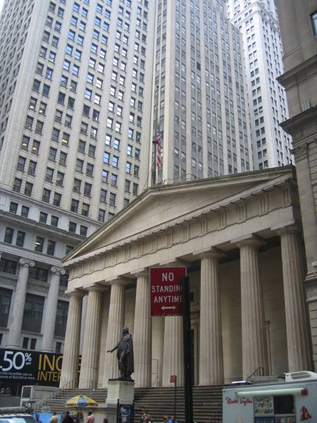Federal Hall on Wall Street, stone columns and Washington statue among skyscrapers