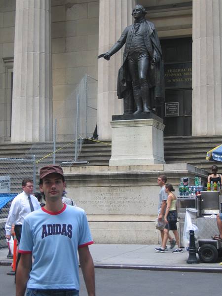 Tourist in Adidas shirt in front of the Washington statue at Federal Hall