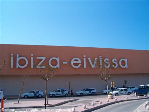ibiza-eivissa sign on the airport entrance, taxis parked under the blue sky