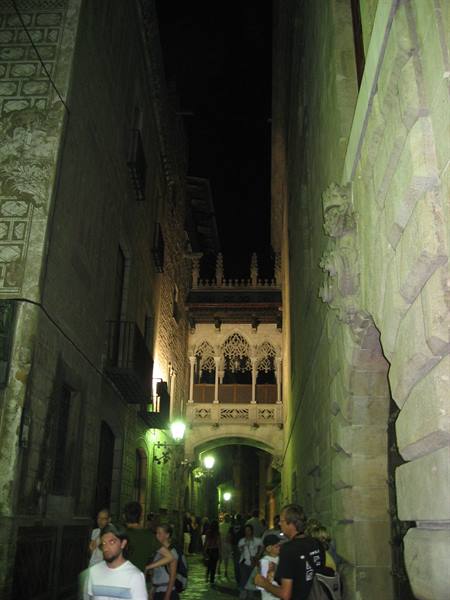 Tourists beneath the neo-Gothic bridge on Carrer del Bisbe, Barcelona's Gothic Quarter