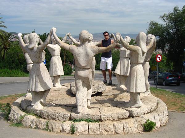 Tourist among circle of dancing stone statues, Montjuïc, Barcelona