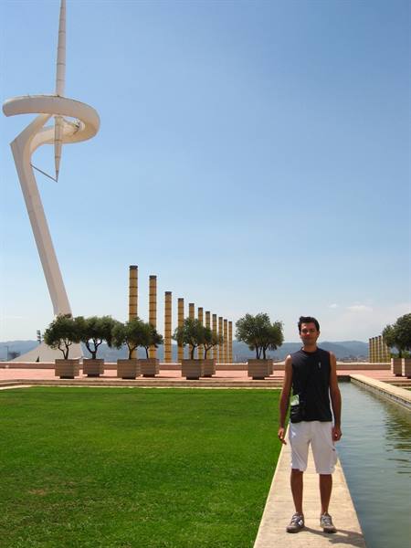 Tourist standing by the pool in front of Calatrava Tower on Montjuïc
