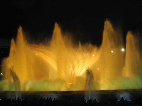 Montjuïc fountain: golden illuminated water jets at night, crowd watching