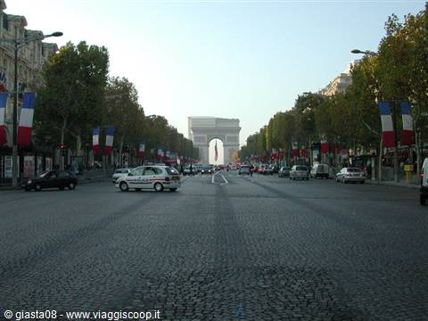 Champs-Élysées with French flags and Arc de Triomphe in morning haze