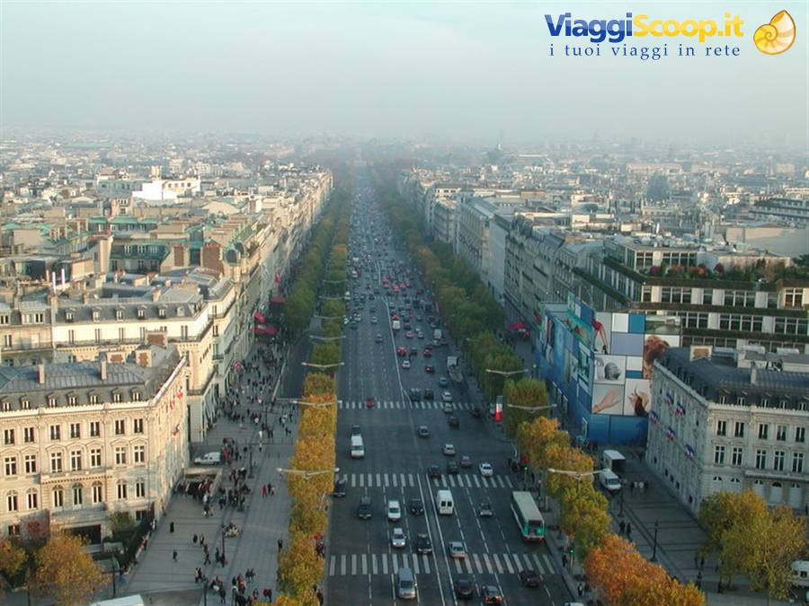 Champs-Élysées avenue seen from the Arc de Triomphe, traffic and Parisian rooftops in haze