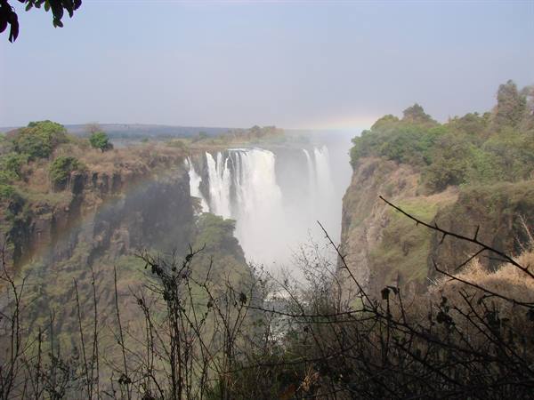 Victoria Falls, water plunging into the gorge with mist and rainbow