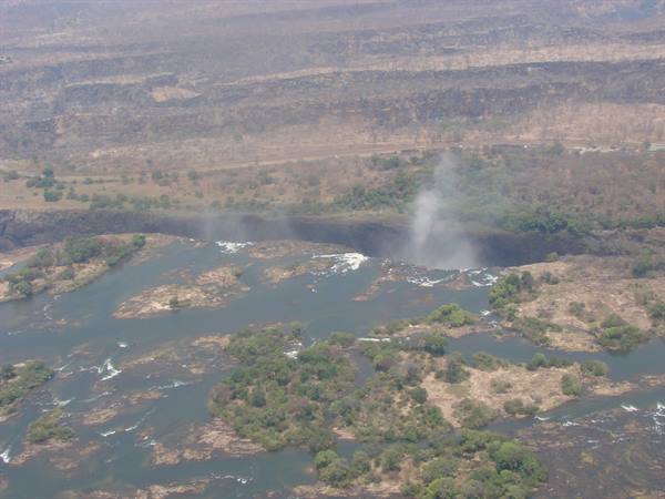 Aerial view of Victoria Falls: the Zambezi River and rising spray