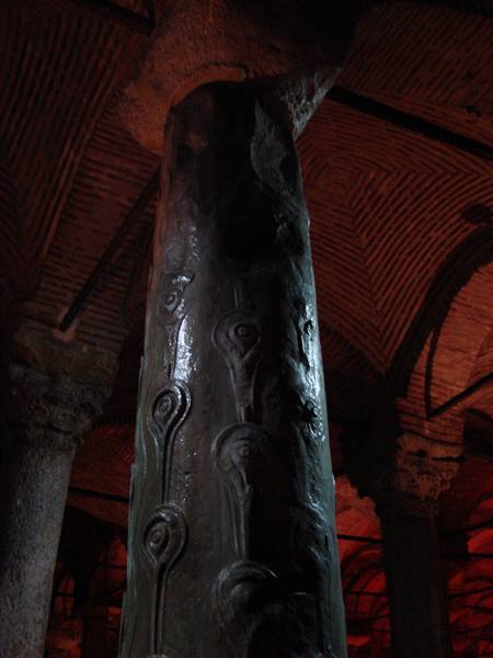 Carved teardrop column inside Istanbul's Basilica Cistern, red lighting
