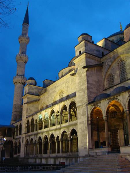 The minaret and arches of the Blue Mosque in Istanbul lit at dusk