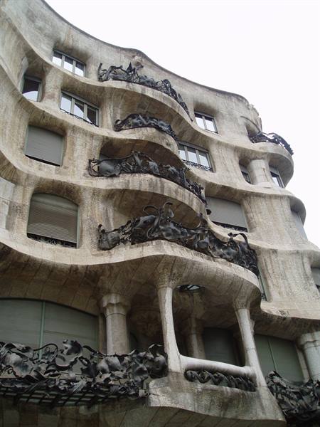 Wavy stone facade of La Pedrera in Barcelona, with wrought iron balconies