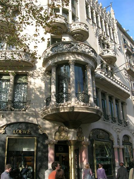 Tourists below the carved stone tribunes of Casa Lleó Morera in Barcelona