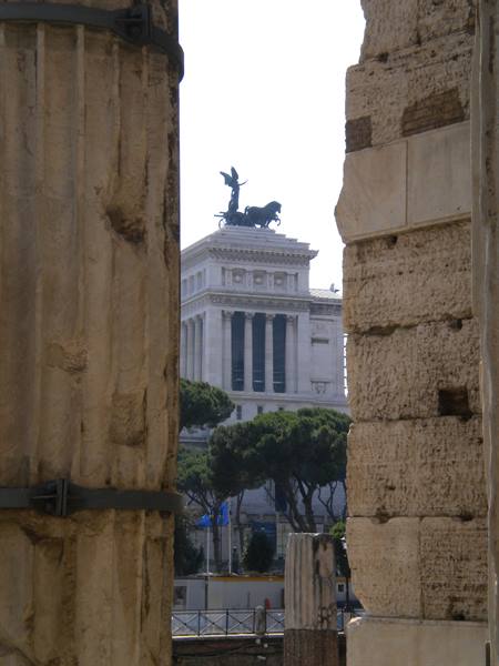 The Vittoriano in Rome framed between ancient travertine columns