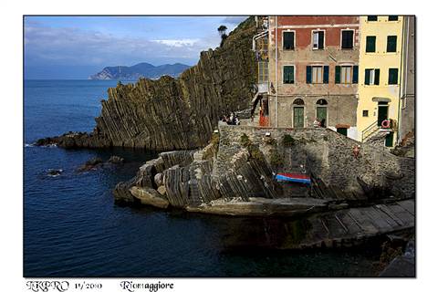 Colorful houses on layered rock above the sea, Riomaggiore
