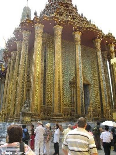 Tourists before the gilded tiled prang of Wat Phra Kaew, Bangkok