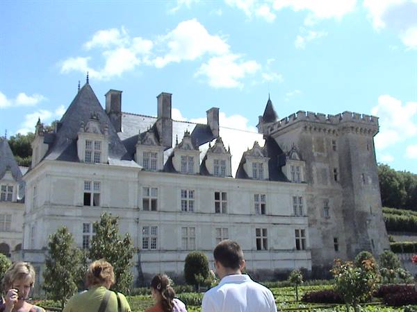Tourists in front of the Château de Villandry, light stone facade and gardens