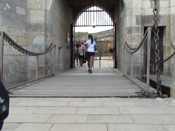 Tourists crossing the stone drawbridge of Saint-Malo citadel