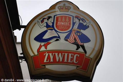 Illuminated Żywiec brewery sign with dancing couple in folk costume
