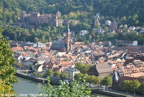Heidelberg Castle overlooks the town and the Neckar river among red rooftops