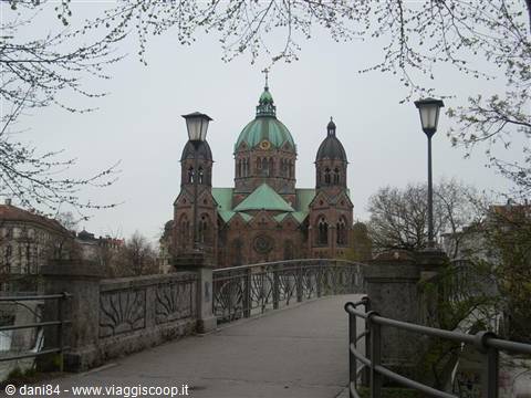 Iron bridge with lampposts leading to St. Luke's Church in Munich
