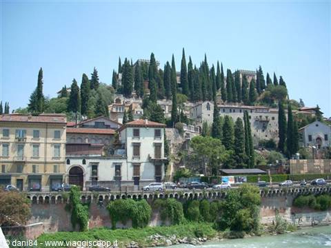 Castel San Pietro hill in Verona with cypresses and houses above the Adige