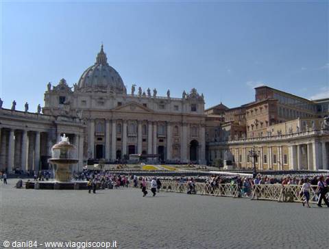 St. Peter's Square with the basilica, fountain and tourists on a sunny day