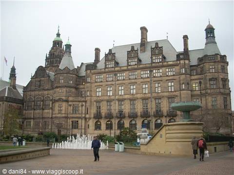Sheffield Town Hall Victorian facade with Peace Gardens fountains and passersby