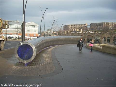 The Cutting Edge steel sculpture outside Sheffield station, pedestrians under a grey sky
