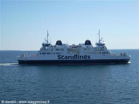 White and blue Scandlines ferry sailing on open sea under clear sky
