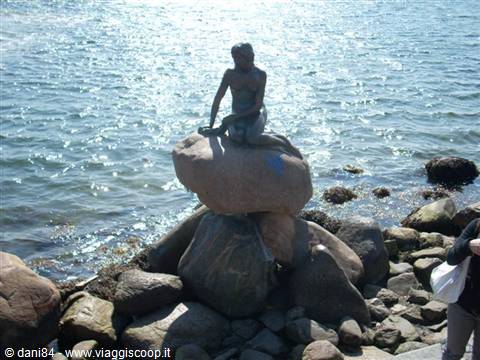 The bronze Little Mermaid statue on a rock in Copenhagen harbor