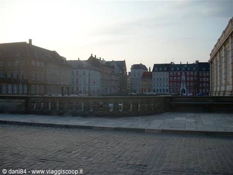 Amalienborg square in Copenhagen, colorful buildings over grey stone pavement