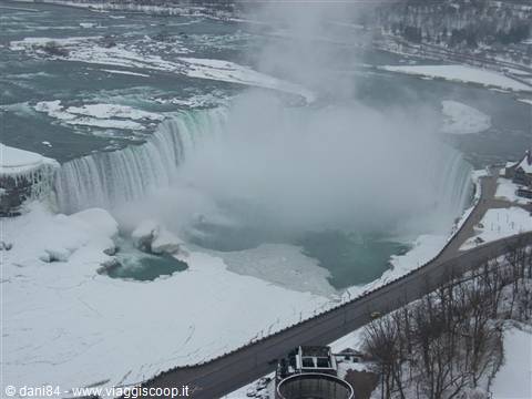 Frozen Niagara Falls in winter, mist rising from snowy Horseshoe Falls