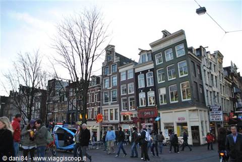 Pedestrians and bikes among historic gabled houses, Amsterdam