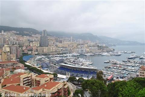 Port Hercules in Monaco: yachts moored, grandstands and buildings under cloudy skies