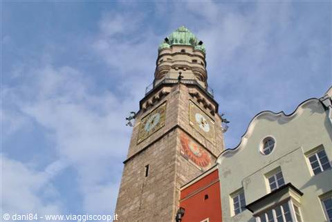 Innsbruck's Stadtturm stone tower with clocks and green copper dome