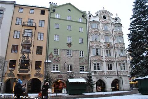 Frescoed facades of Innsbruck's colorful historic buildings under the snow