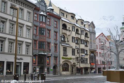 Ornate facades along Maria-Theresien-Straße in Innsbruck, snowy mountains behind